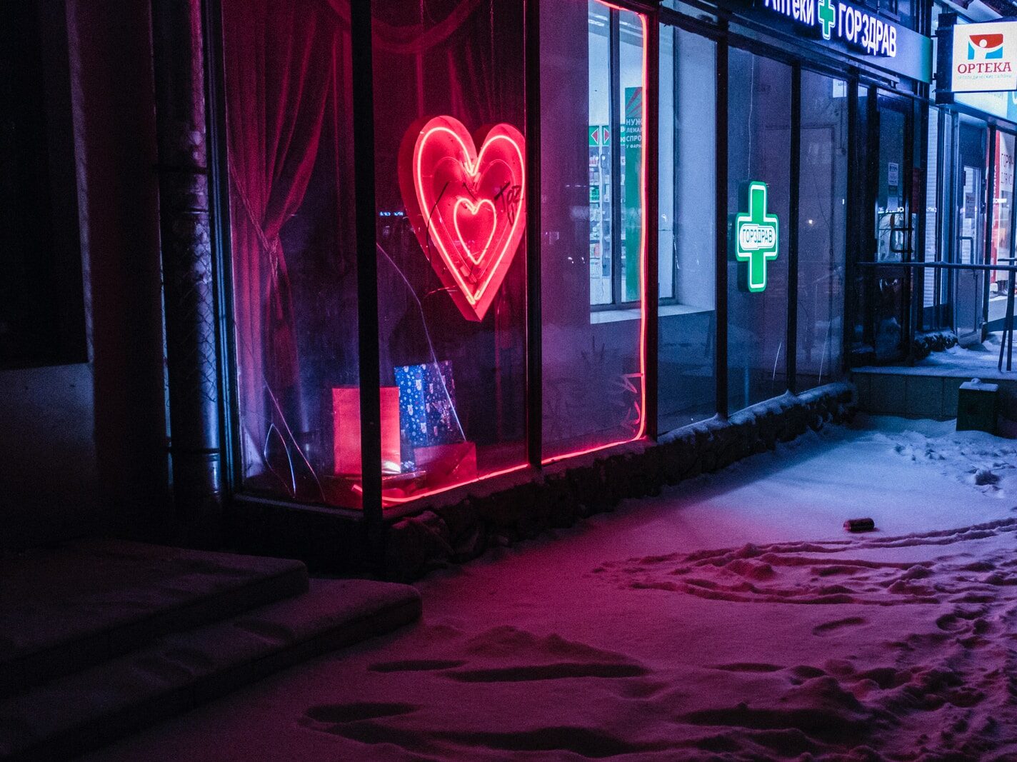 red and green neon light signages on building at nighttime