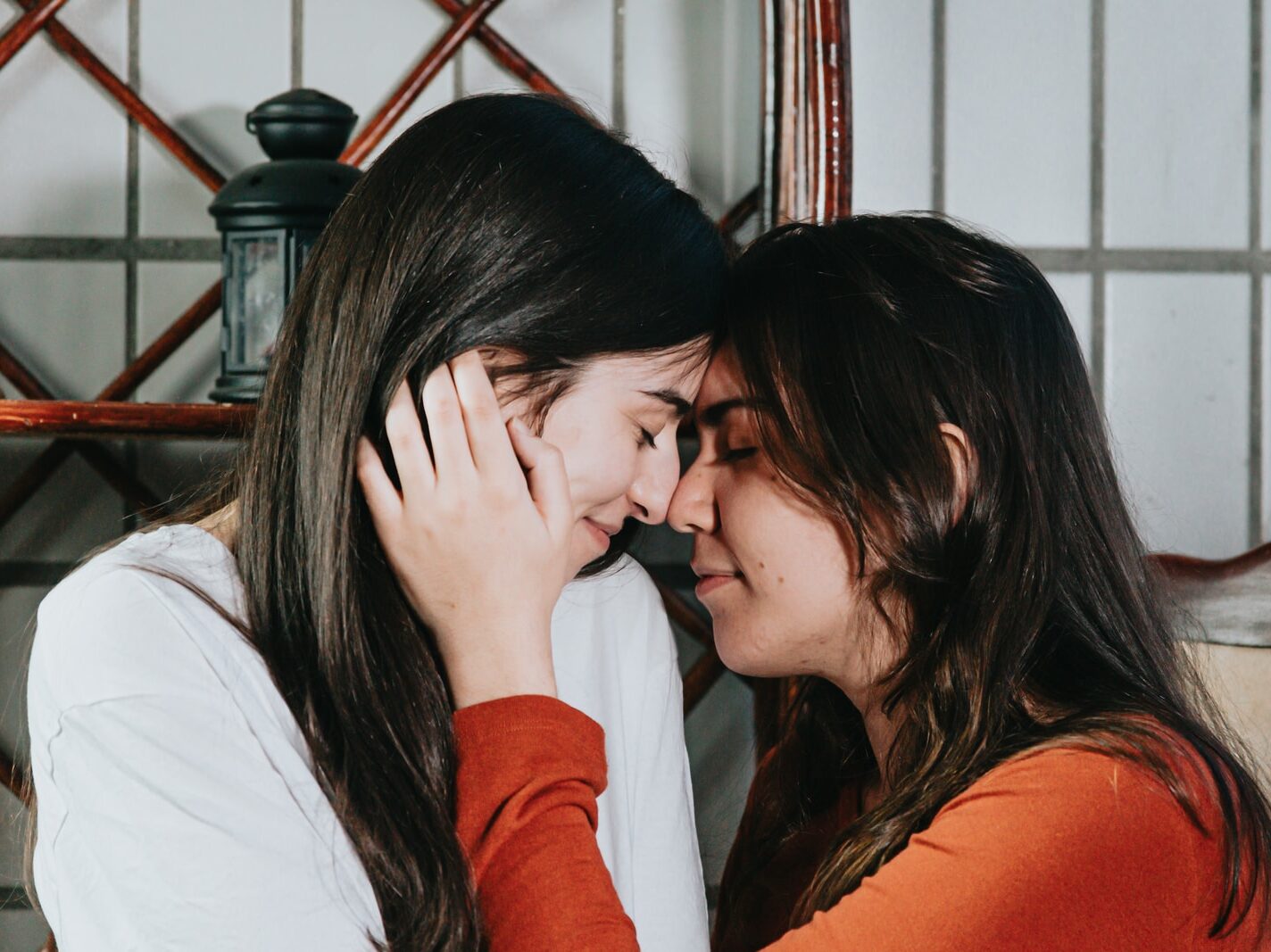 woman in white long sleeve shirt covering her face