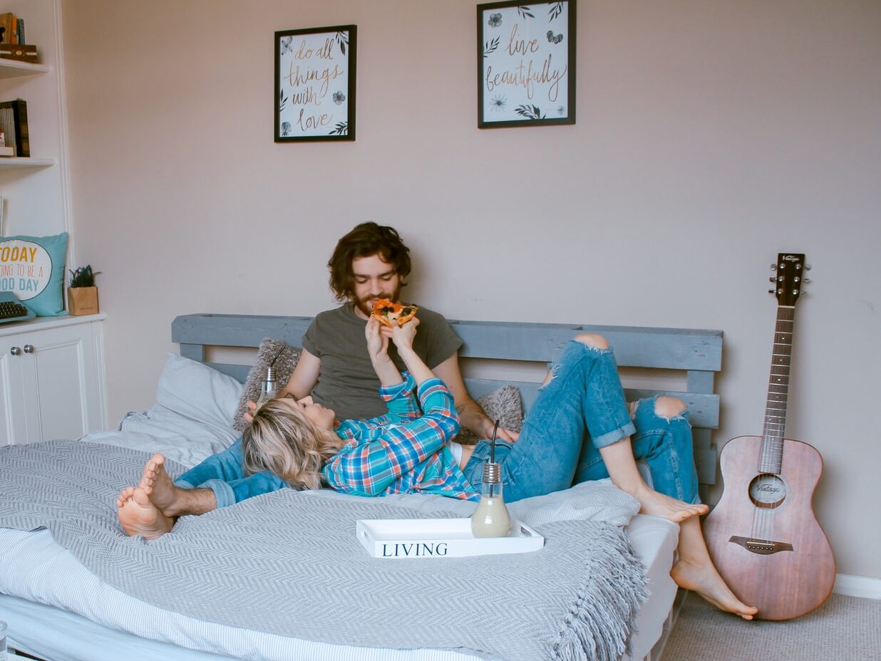 man and woman lying on bed