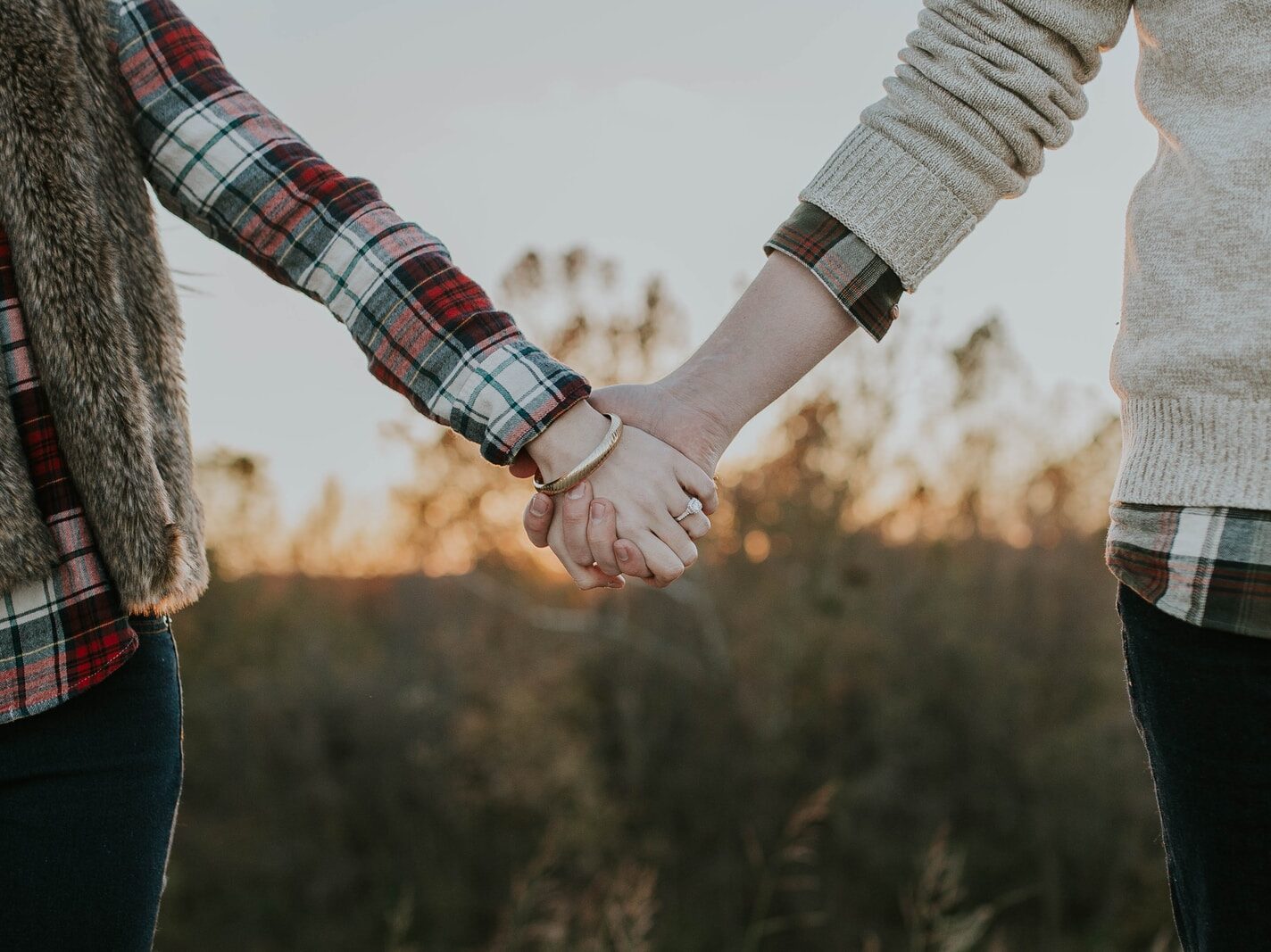 two person holding hands while standing