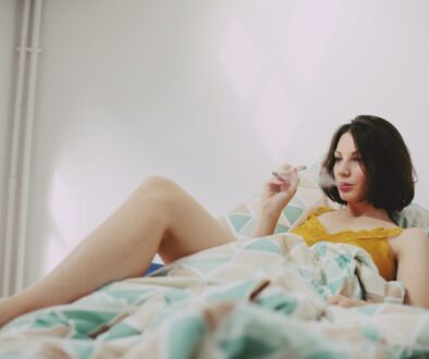 woman in yellow shirt lying on bed