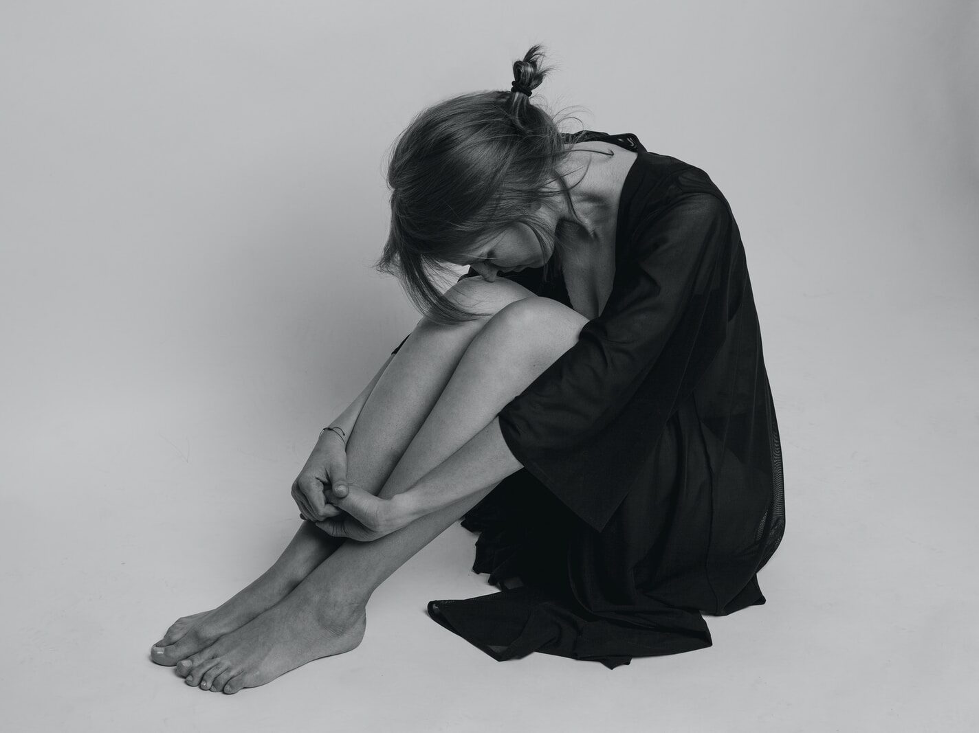 woman in black dress sitting on floor