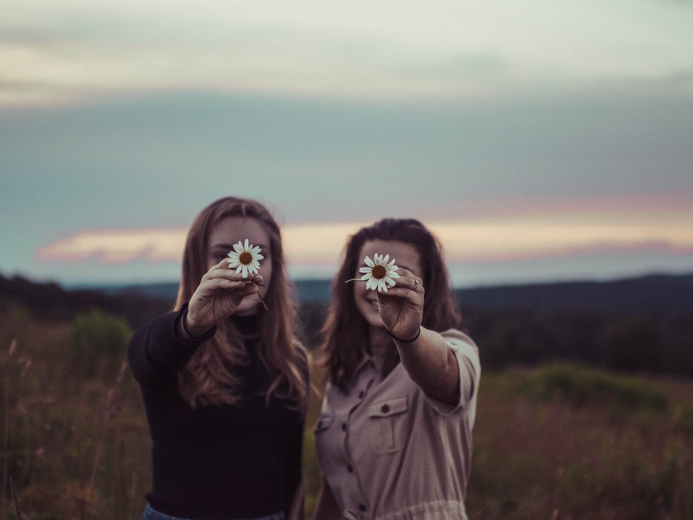 two women holding flowers