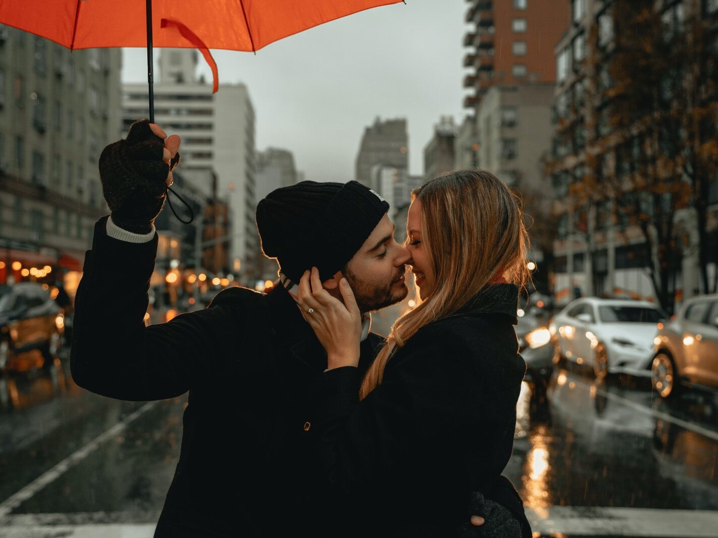 woman in black jacket holding red umbrella during daytime