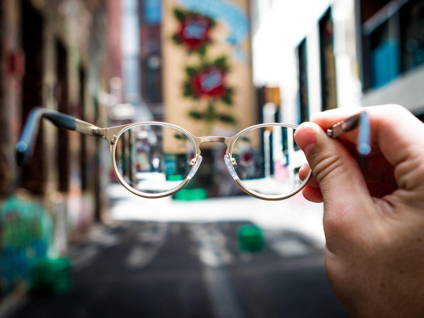 person holding eyeglasses