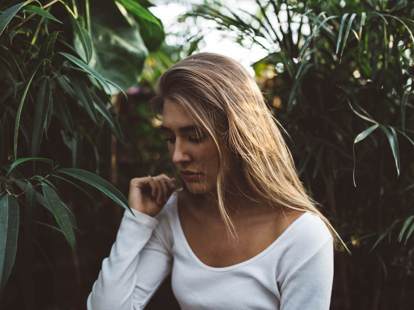 woman near green leafed plants