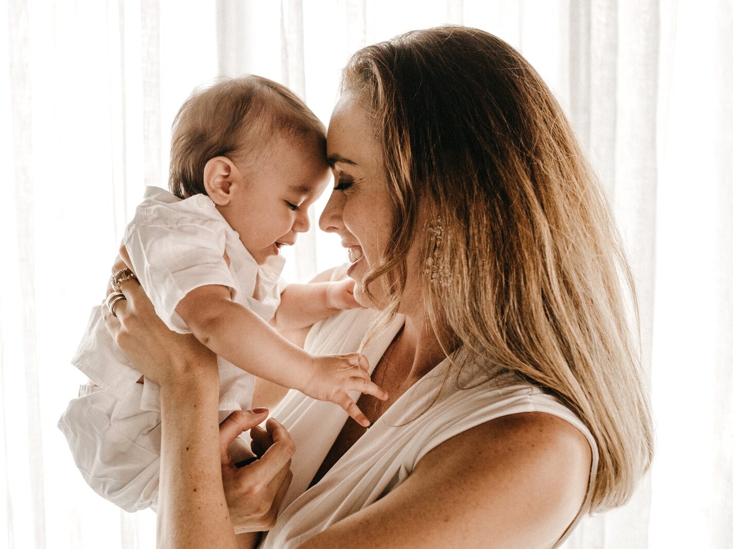 smiling woman carrying baby