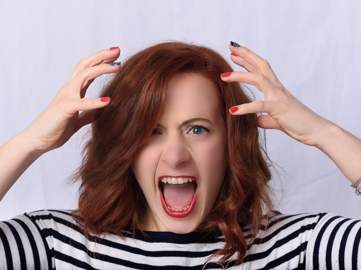 smiling girl in black and white striped shirt
