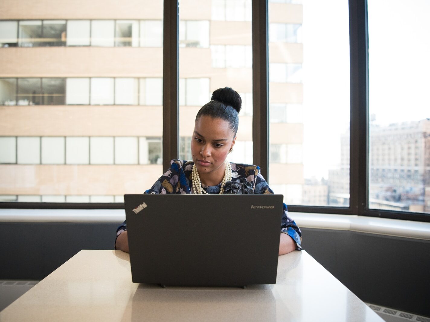 woman using Lenovo laptop