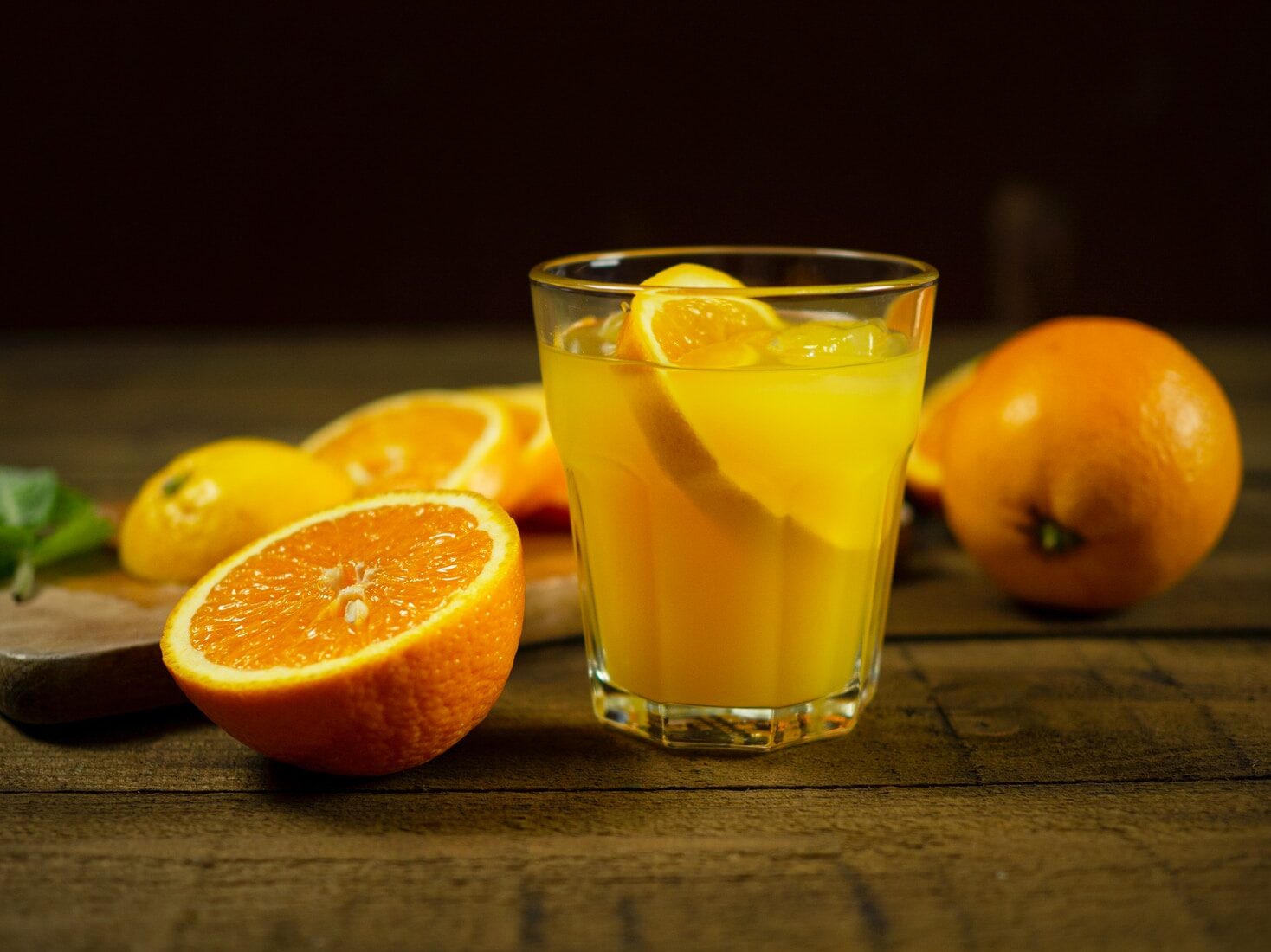 orange juice in clear drinking glass