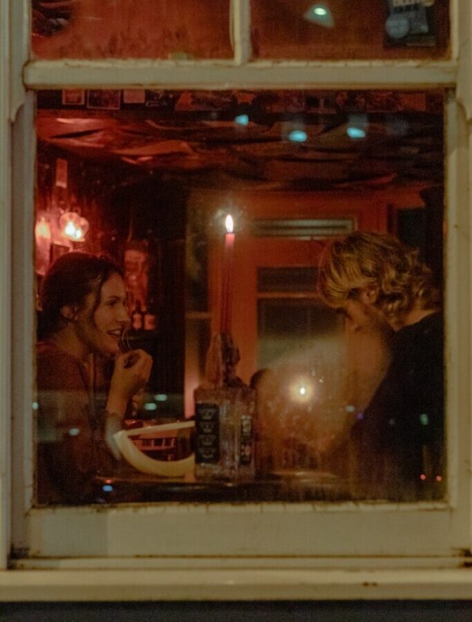 woman in black tank top beside woman in white tank top