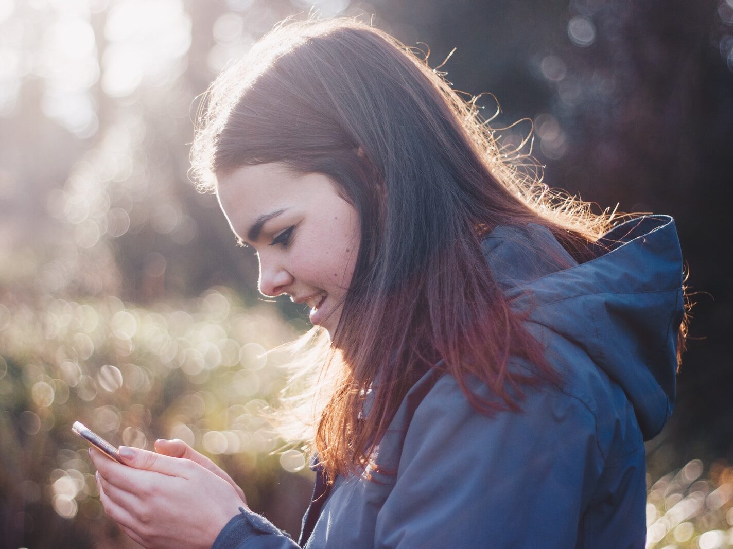woman holding phone smiling