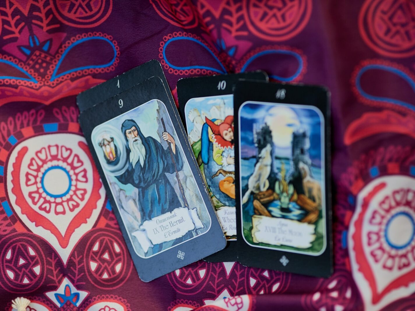 2 trading cards on red and white textile