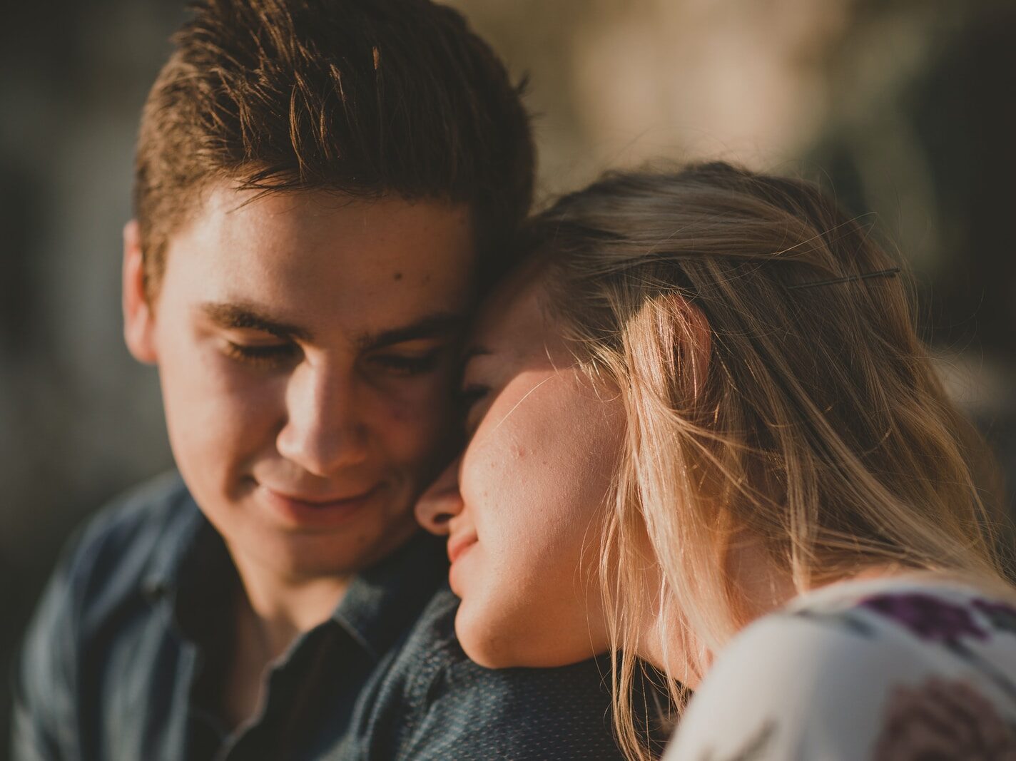 woman leaning on man's shoulder