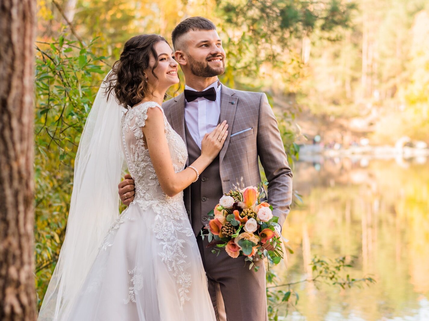 man in gray suit and woman in white wedding dress