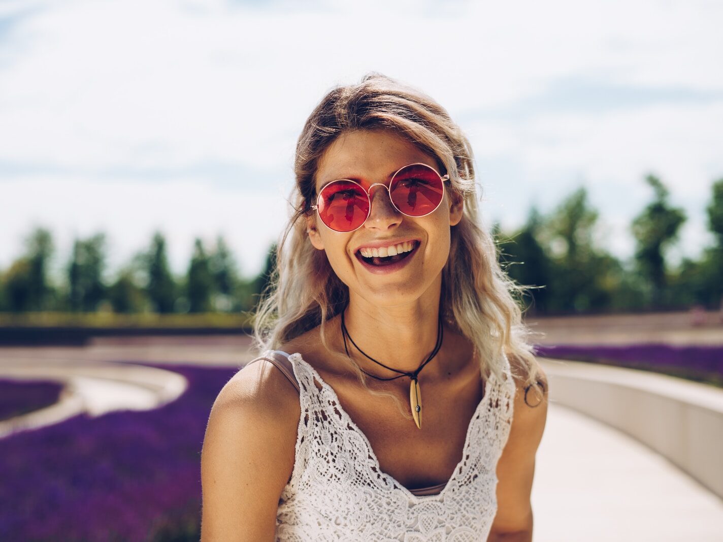 woman in white floral tank top wearing sunglasses