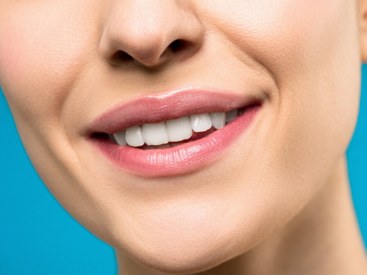Close-up Photo of Woman With Pink Lipstick Smiling
