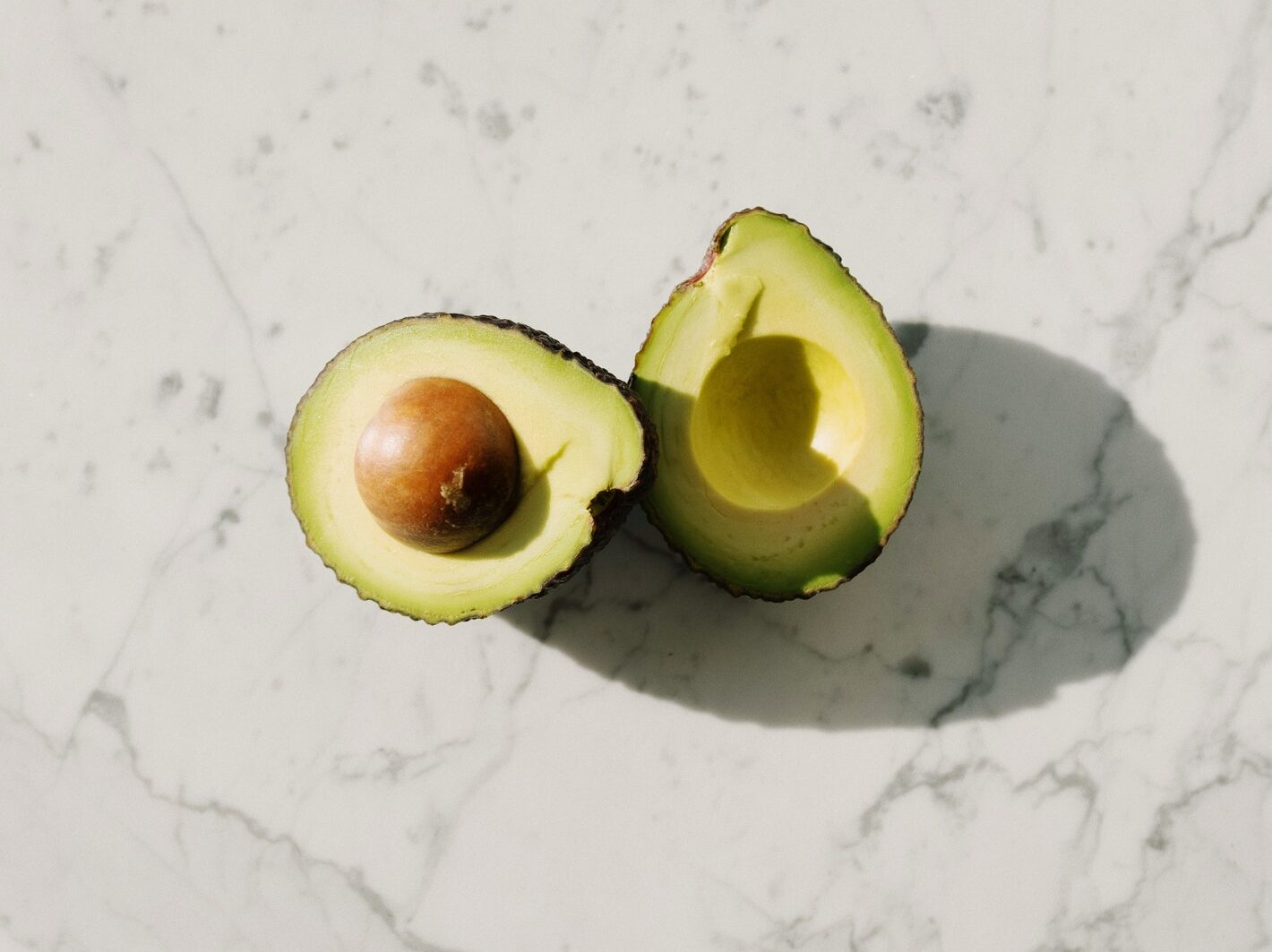 Sliced Avocado Fruit On White Surface