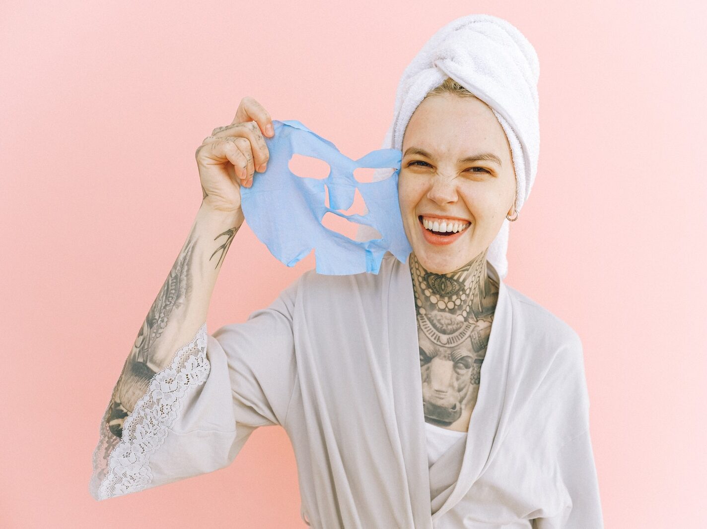 Happy woman removing face mask after taking bath