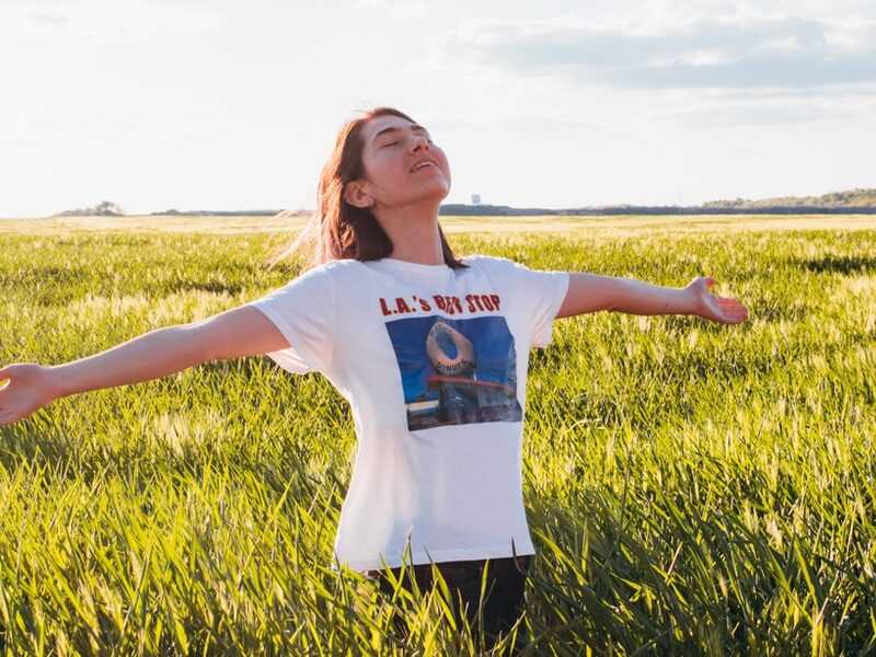 woman standing in green field