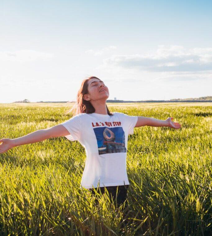 woman standing in green field