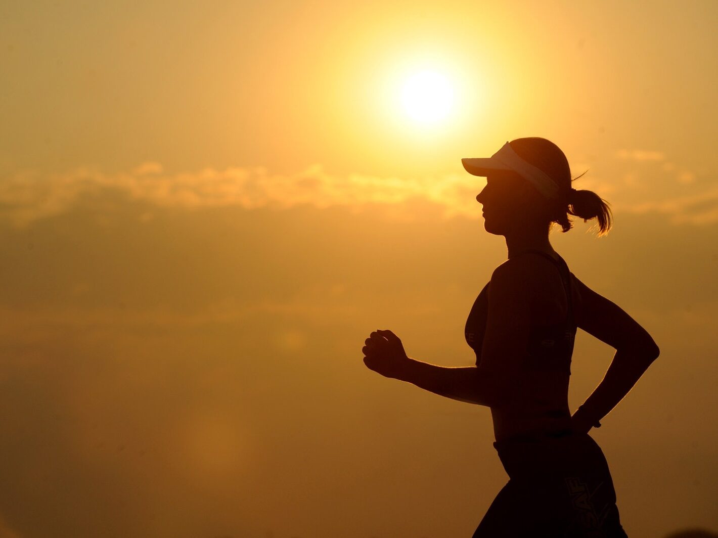 Woman With White Sunvisor Running