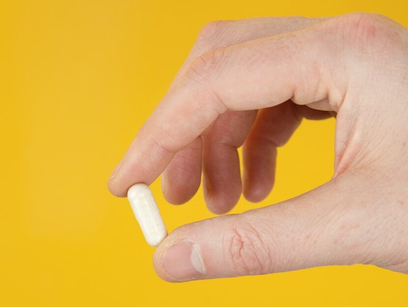 person holding white cigarette stick