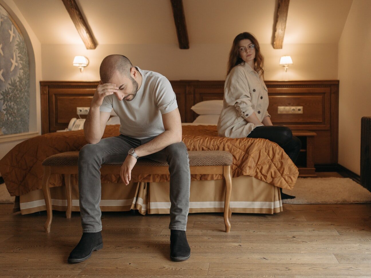 Man and Woman Sitting on Brown Wooden Chair