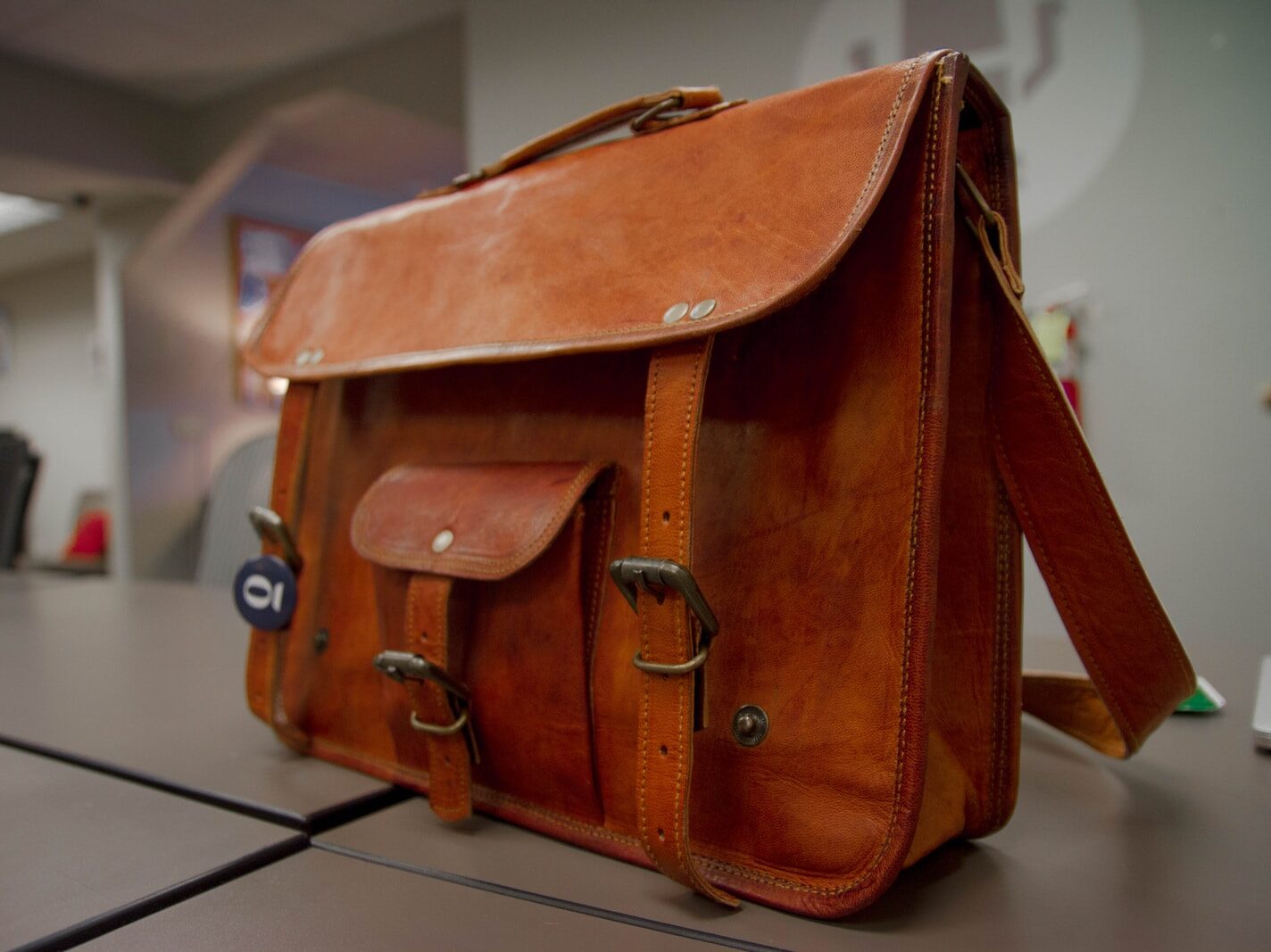 closeup photo of brown leather crossbody bag