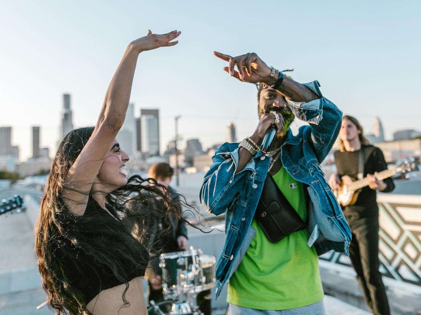 Man in Green T-Shirt Singing Beside Smiling Woman with Raised Hand