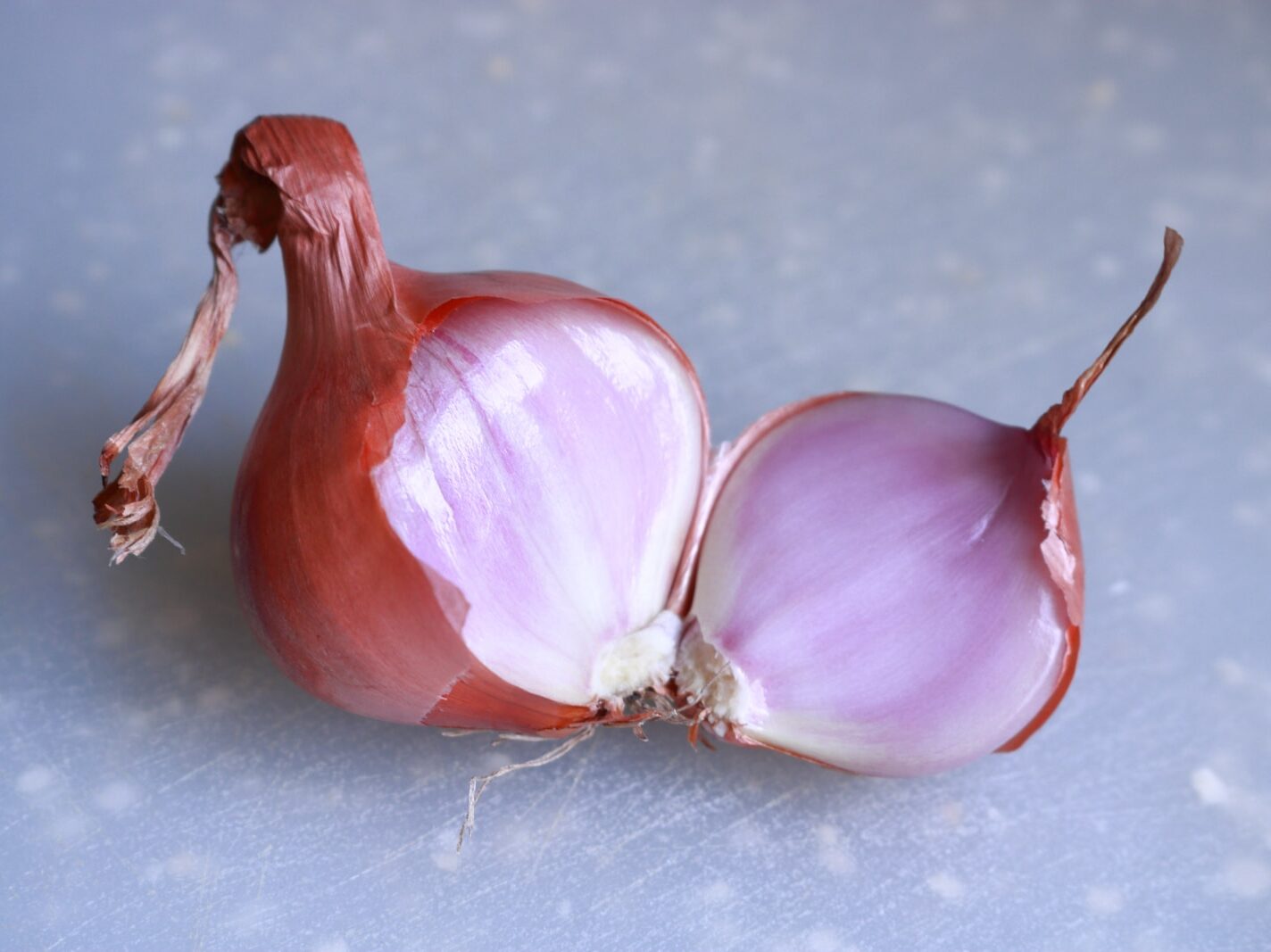 2 red onions on white table