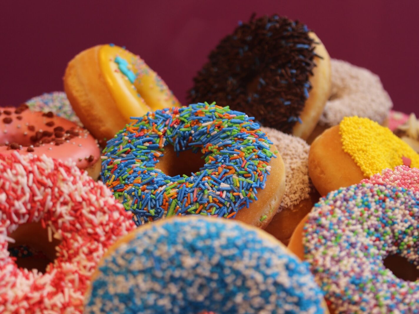 blue and pink doughnut on white textile