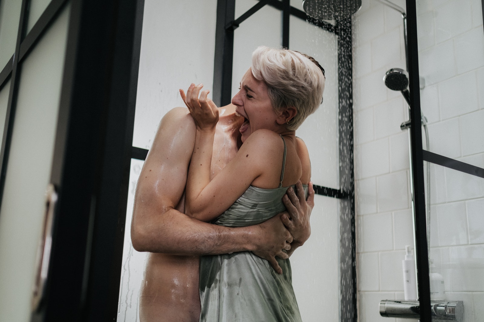 Naked Man Hugging Woman in Green Dress in the Shower