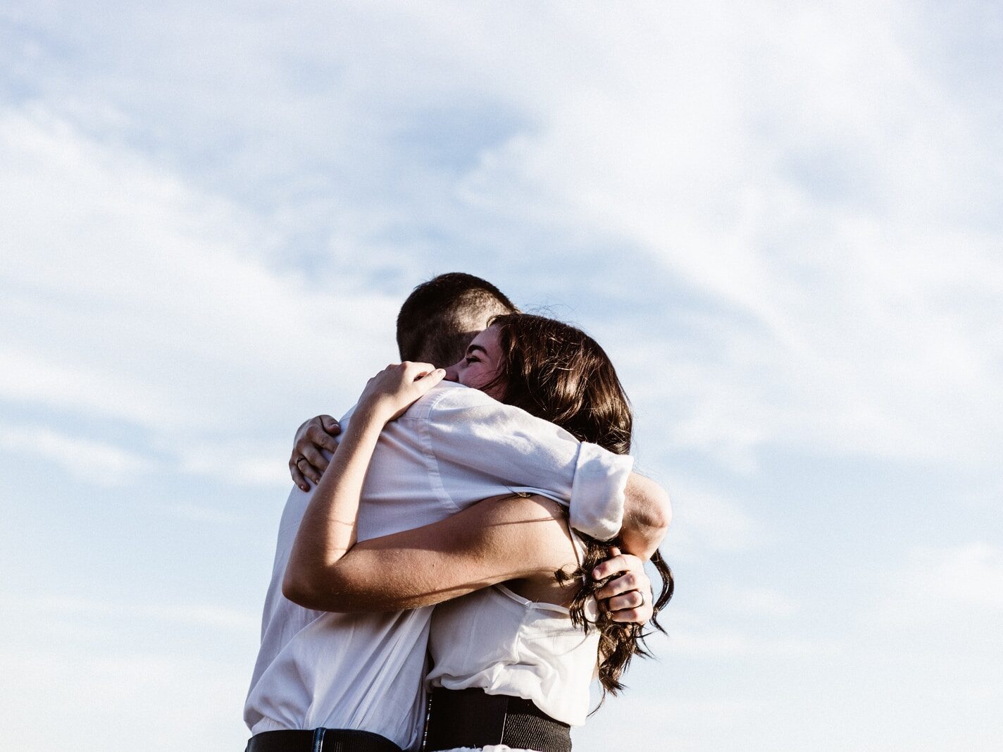 man and woman hugging each other photography