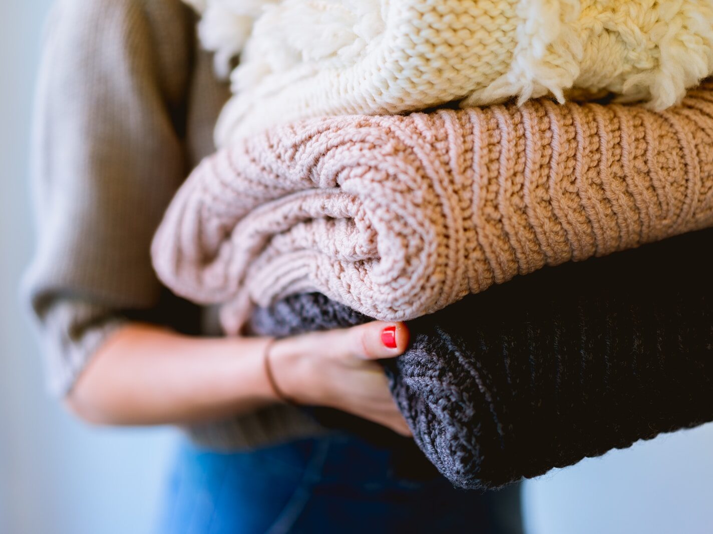person holding knitted textiles