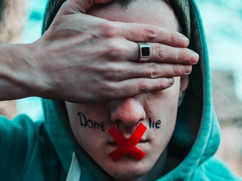 man in teal hoodie with i love you text