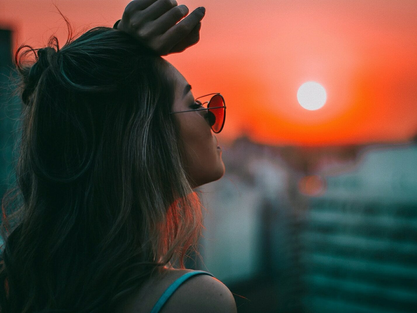 woman putting her left arm on her forehead