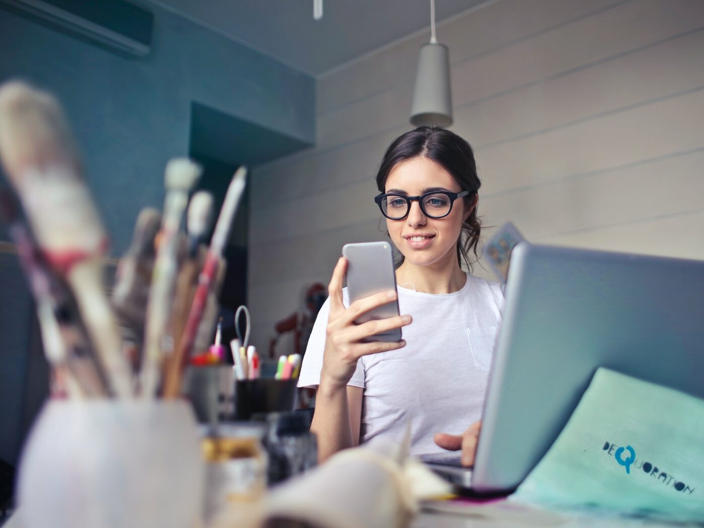 woman in white shirt using smartphone