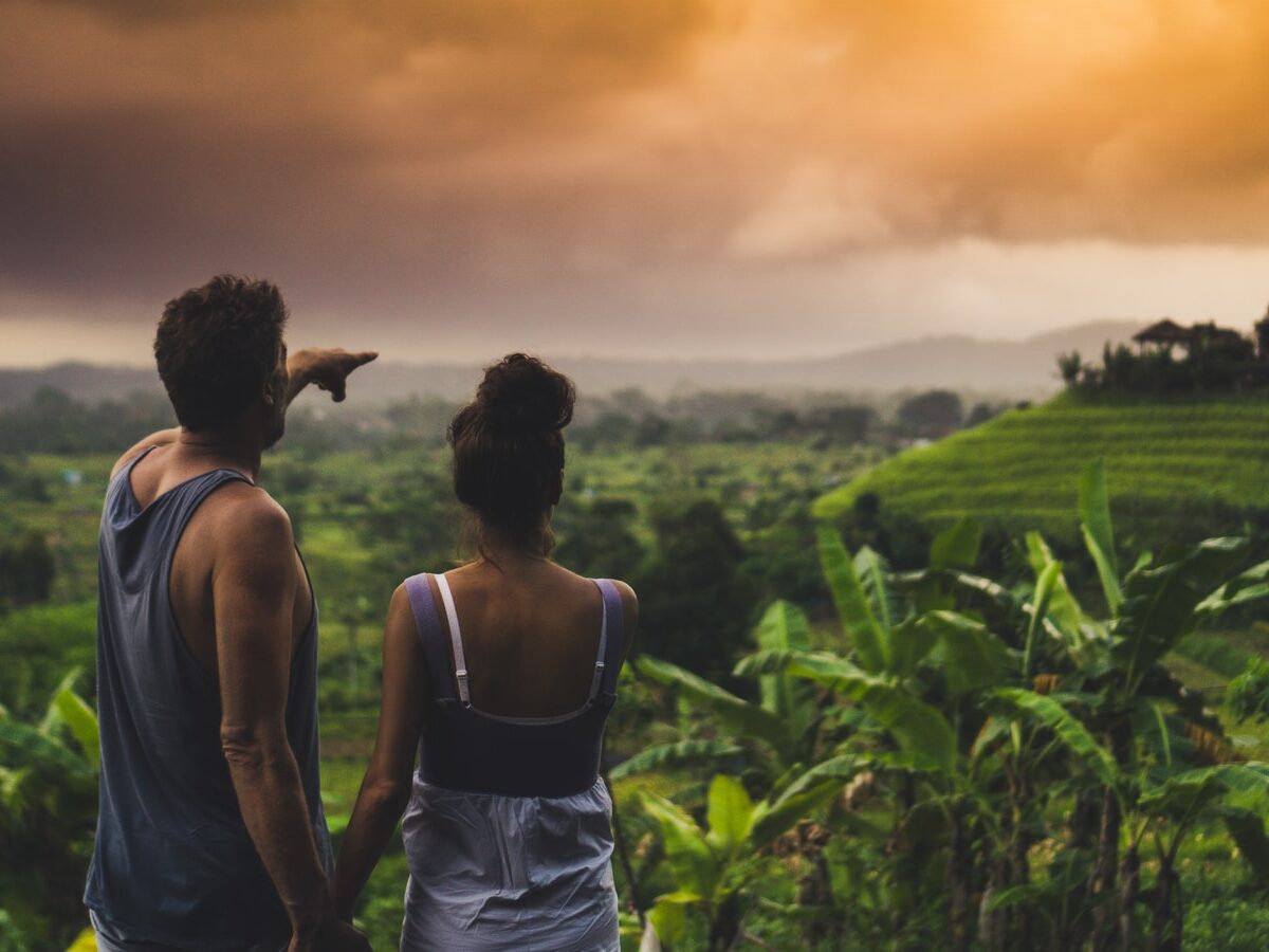 man and woman looking at hill