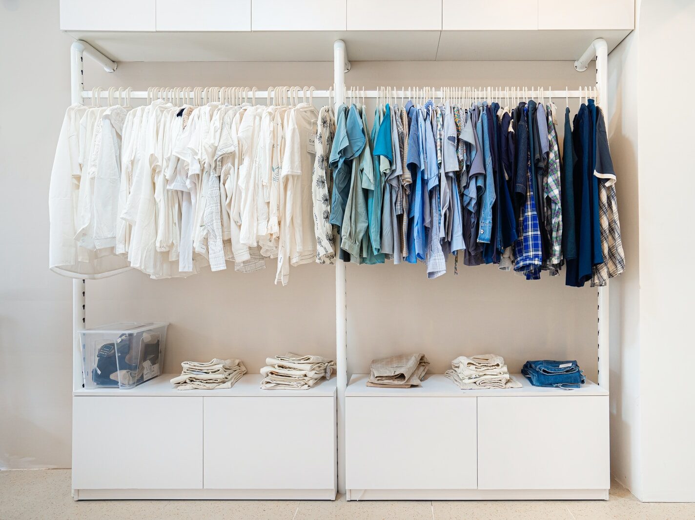 white and blue shirts hanging on white wooden cabinet