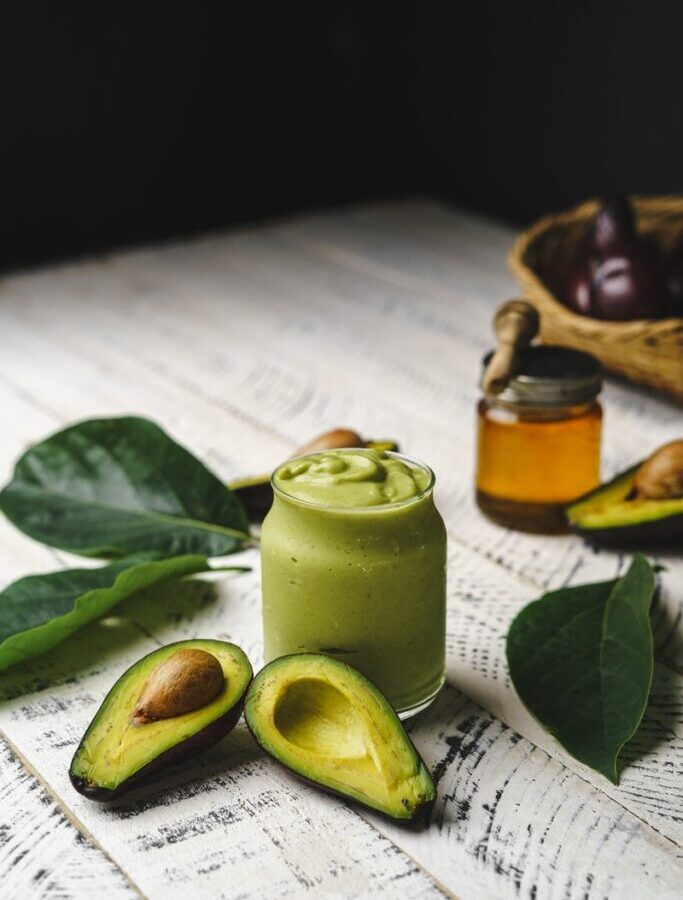 green pillar candle on white paper