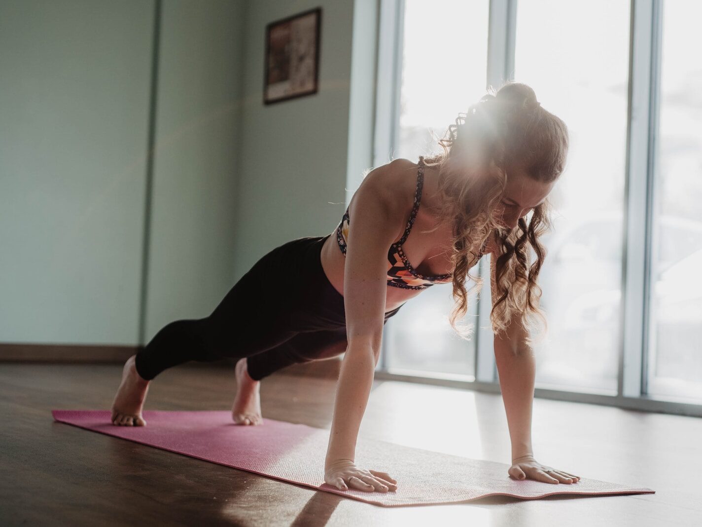 woman in black tank top and black leggings doing yoga