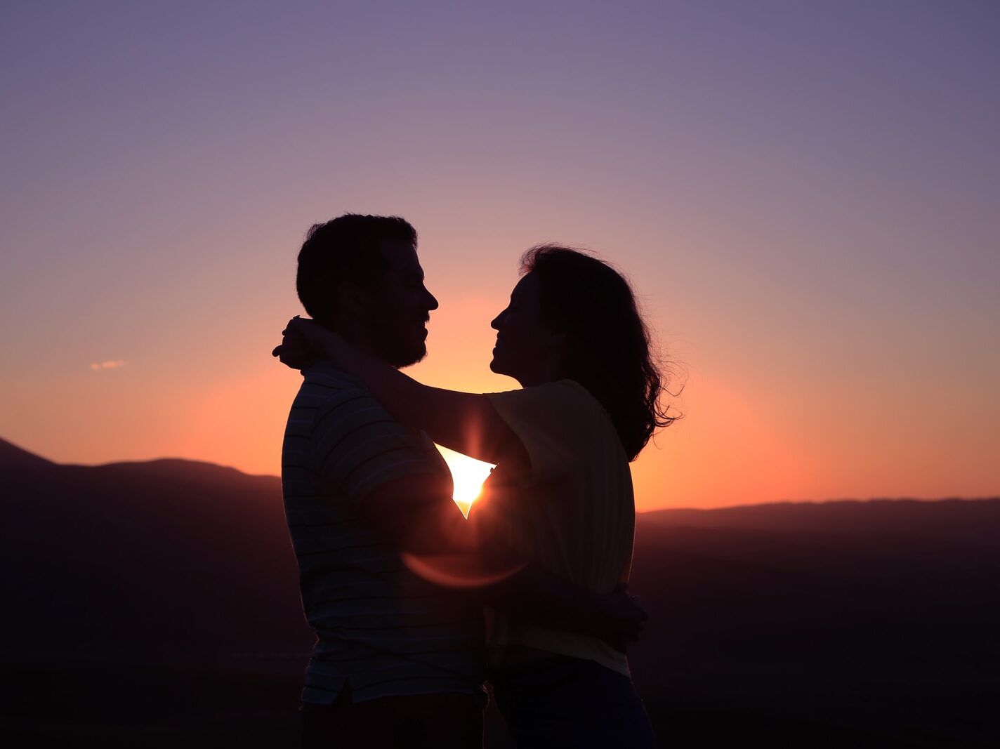 silhouette of hugging couple