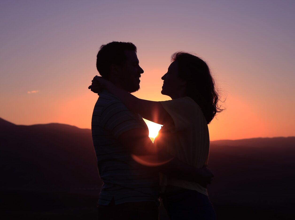 silhouette of hugging couple
