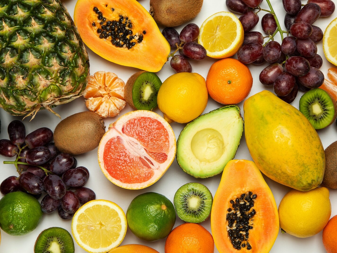 sliced orange fruit and green round fruits