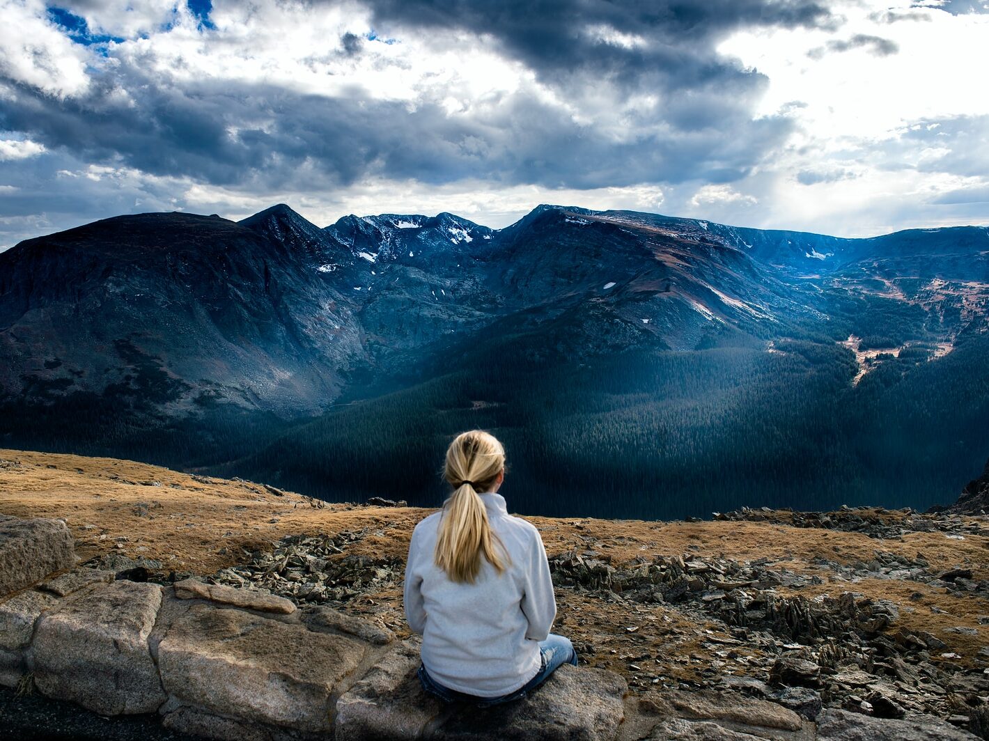 woman sitting on gray stone