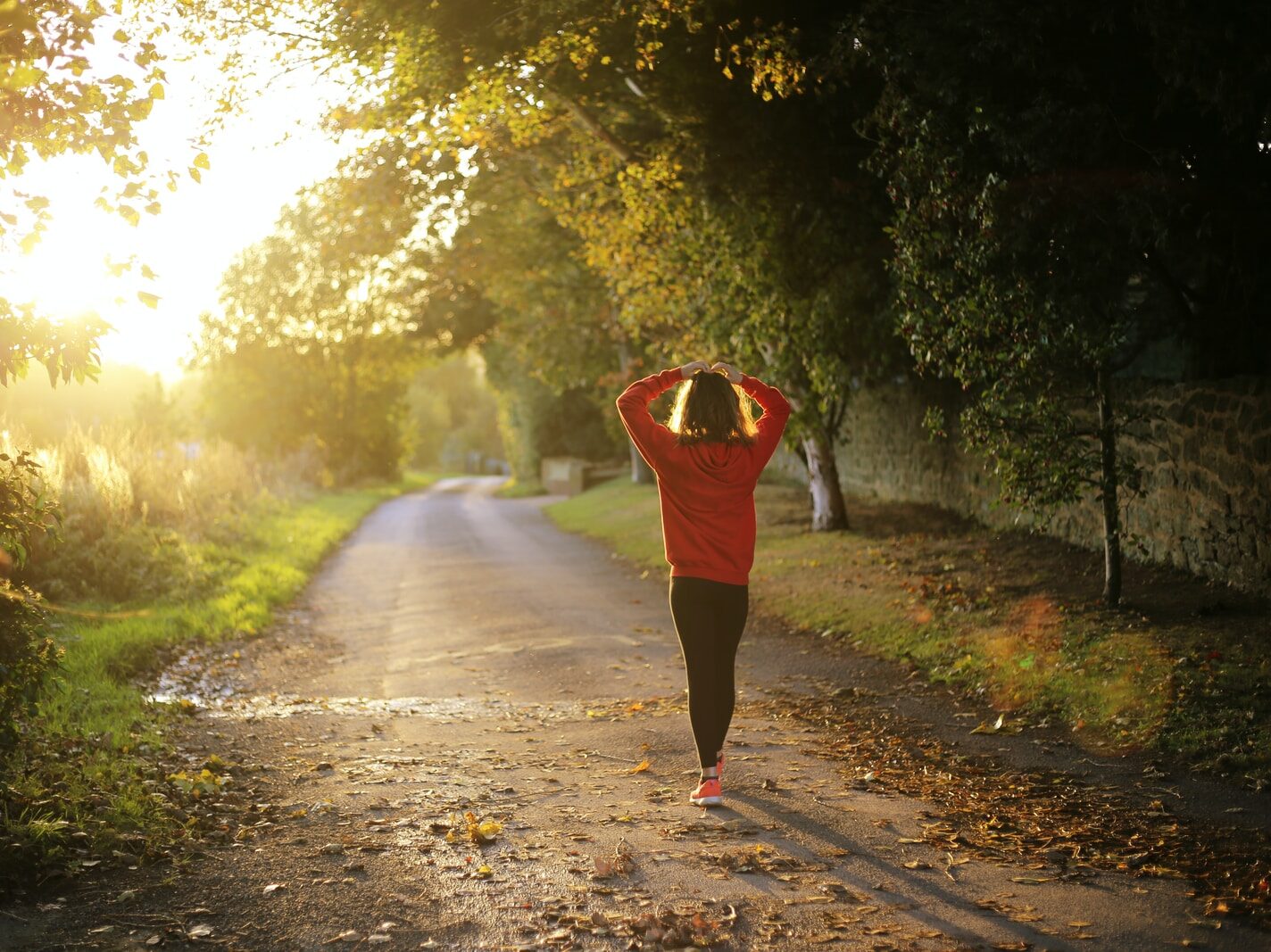 woman walking on pathway during daytime