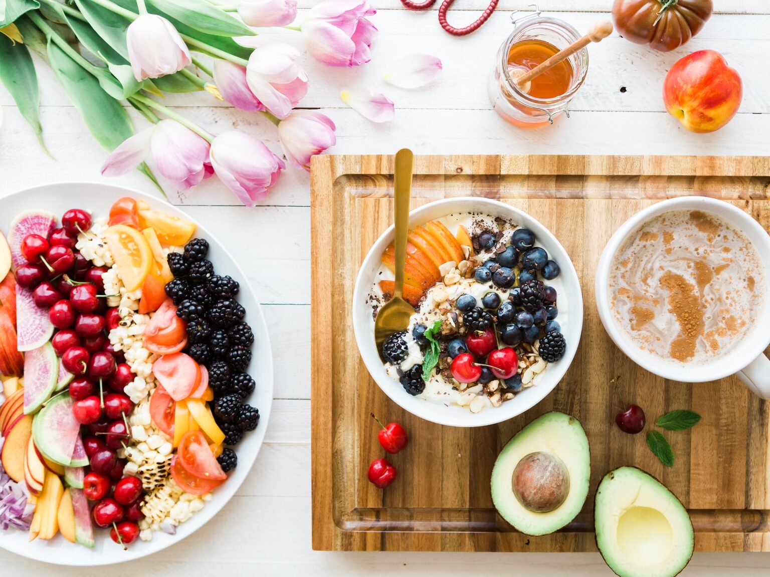 black and red cherries on white bowl