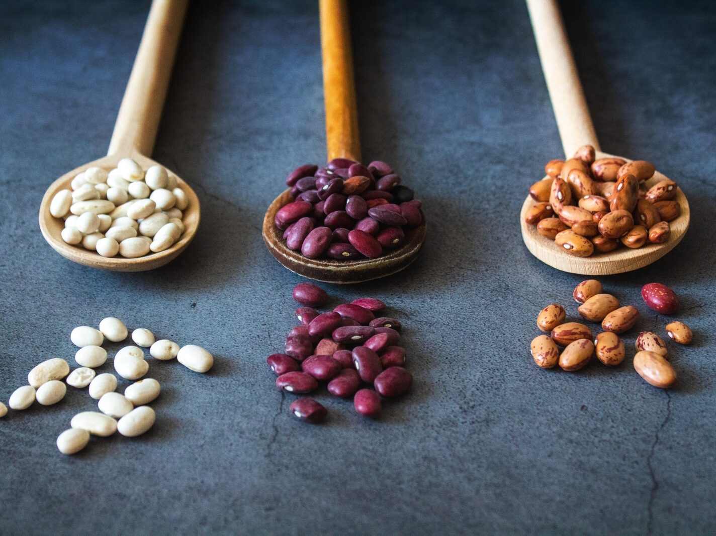 brown wooden spoon with red and brown beans