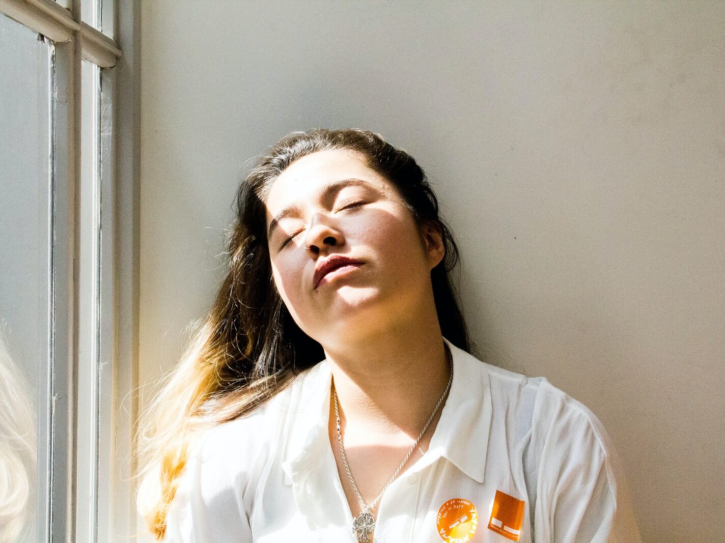 woman standing near window during daytime